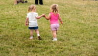 Two small girls holding hands preview
