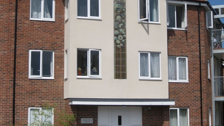 Ceramic panel embedded into the front of a three-storey block of flats