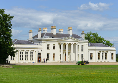 Front of Hylands House, a Grade II* neo-classical white villa with a portico entrance featuring four columns