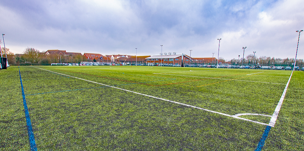 Football pitch surrounded by floodlights