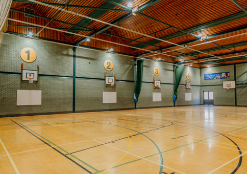 Basketball hoops around the edge of SWFLC sports hall