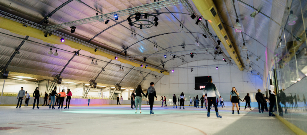 Lots of people skating on the indoor ice rink at Riverside