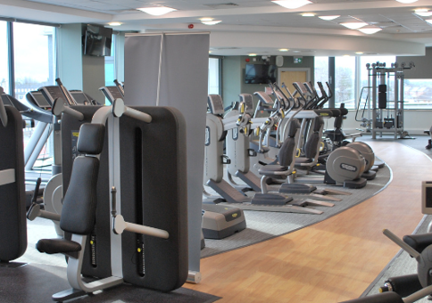 Gym filled with cardio equipment and weights machines