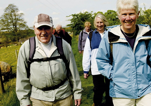 Group of older people walking in countryside