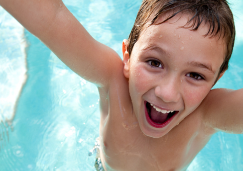 Excited-looking boy in a pool