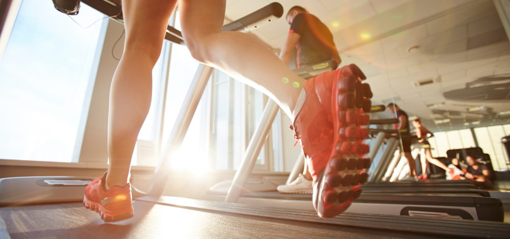 Person's feet running on treadmill