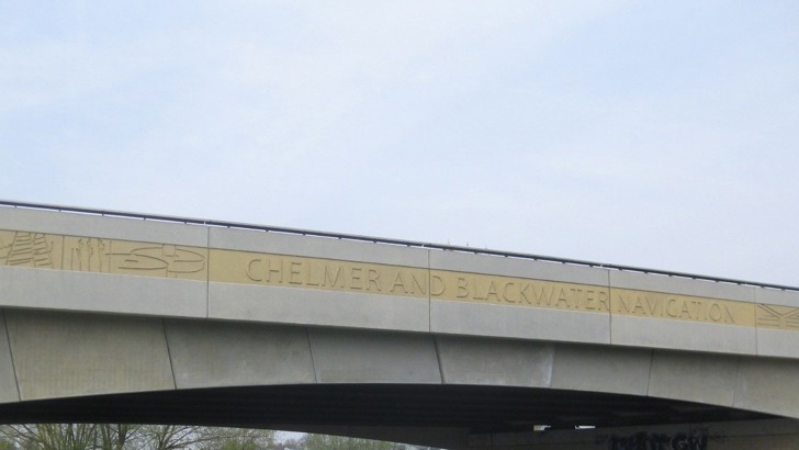 Pictures engraved on bridge with the words 'Chelmer and Blackwater Navigation'
