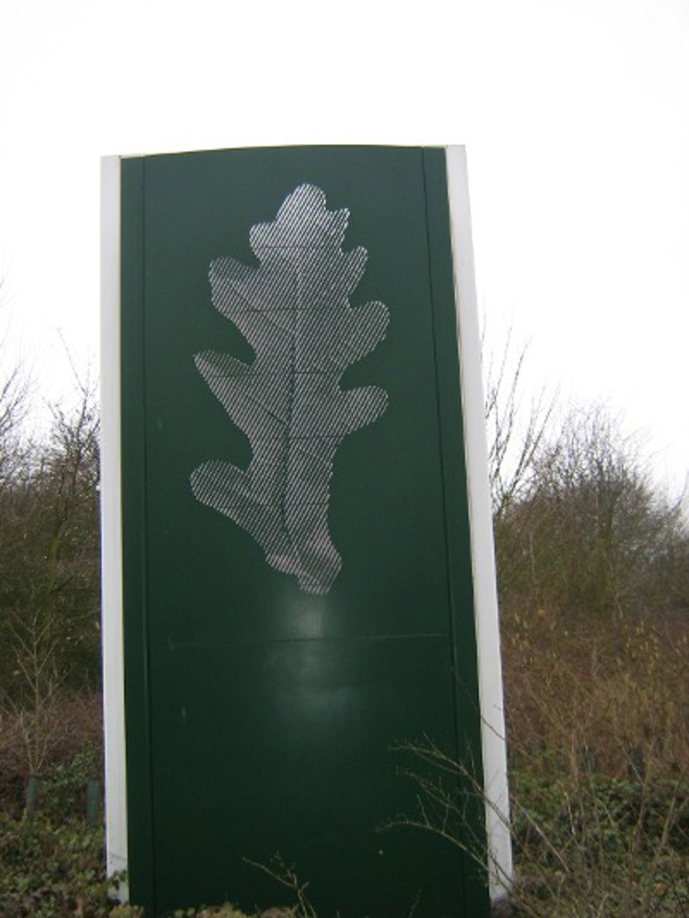 Sculpture of an oak leaf on a green background