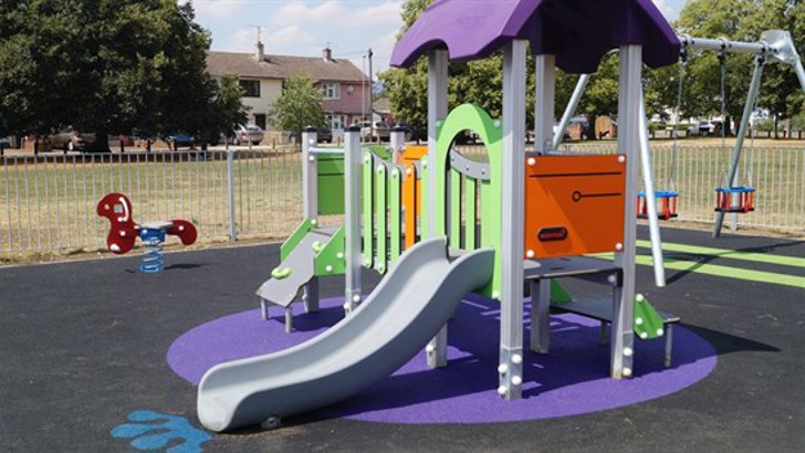 Play area with slide and swings