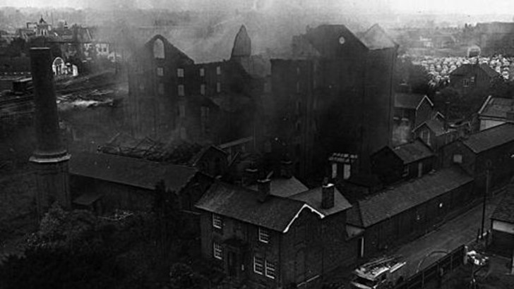 Burnt out building with smoke sill rising from it