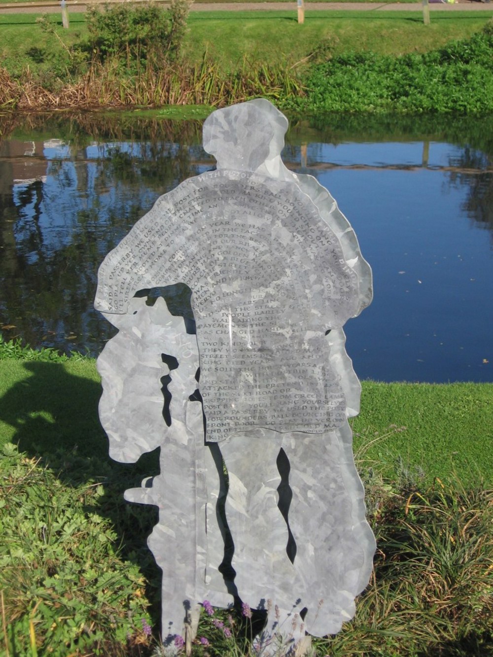 Sculpture of a man in front of river