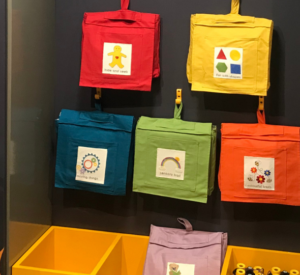 Colourful children's backpacks on wall display