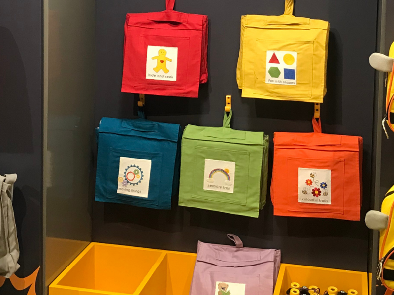 Colourful children's backpacks on wall display