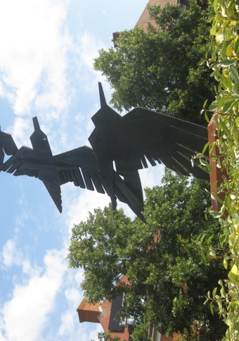 Sculpture depicting four black steel birds in flight, of decreasing sizes