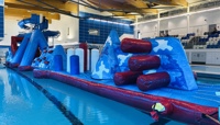 Large blue and red inflatable assault course floating on top of water at Riverside swimming pool preview