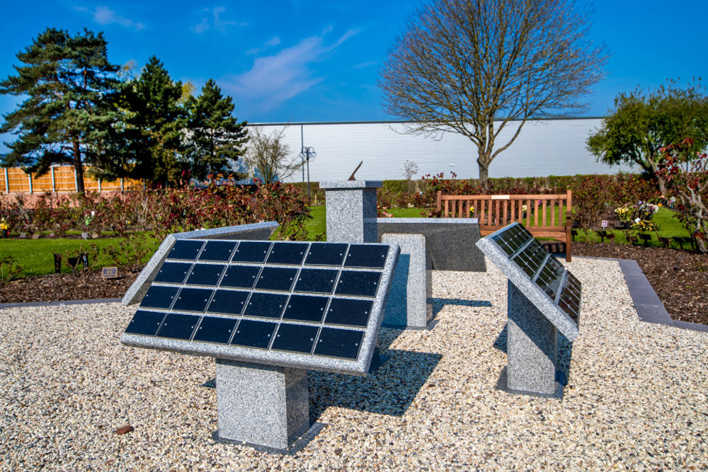 Four large stone lecterns with grid of plaques