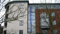Blue glass panels depicting stylized river in window of block of flats preview