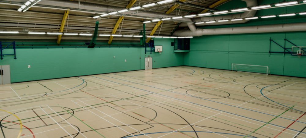 Large sports hall with various marking on the fllor for different sports