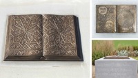 Bronze statue of book on a plinth, engraved with 'But now this park where deer would graze and roam' preview