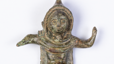 A tiny statue wearing a hooded cloak