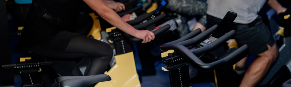 People on stationary bikes in spin studio