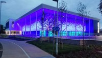 Riverside Leisure Centre lit up blue at dusk preview