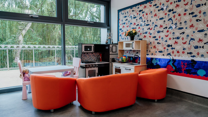 Kitchen play area with orange seating