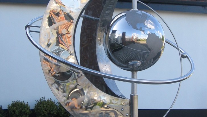 Steel sculpture with a globe in the middle